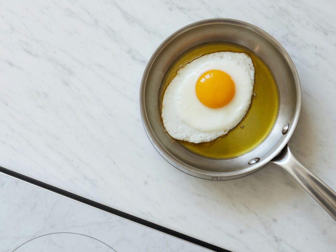 One egg frying in a small skillet