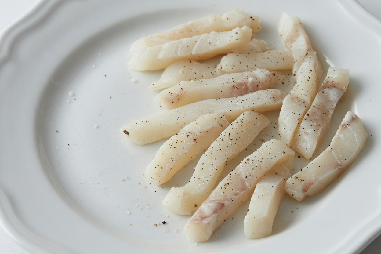 White fish cut into strips and seasoned