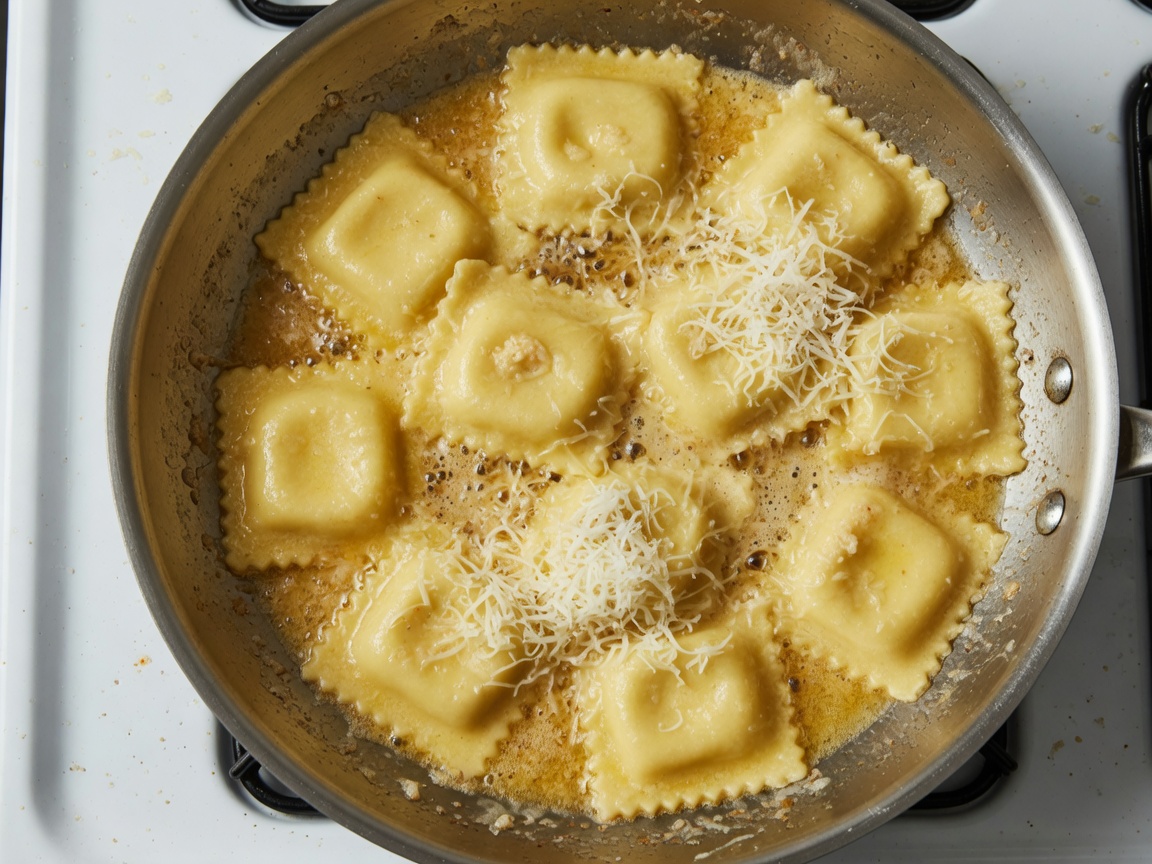 Tossing homemade cheese ravioli in brown butter with Parmesan