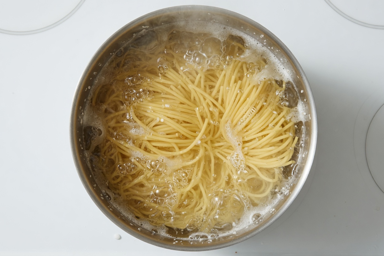 Spaghetti boiling in salted water