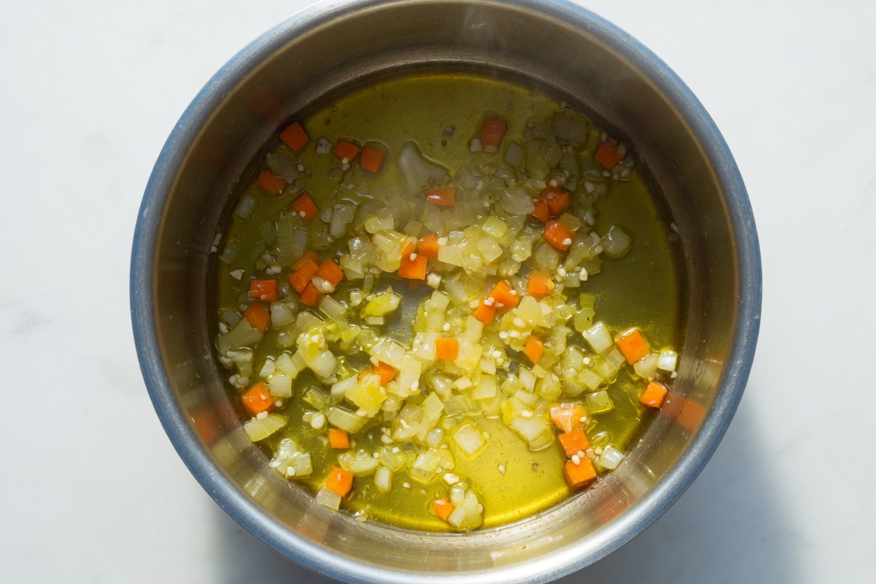 Onion and carrot softening in olive oil